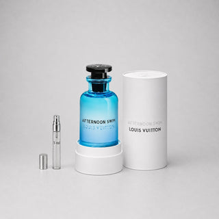 Louis Vuitton Afternoon Swim Sample Spray features a blue glass bottle with a black cap, accompanied by a white cylindrical b