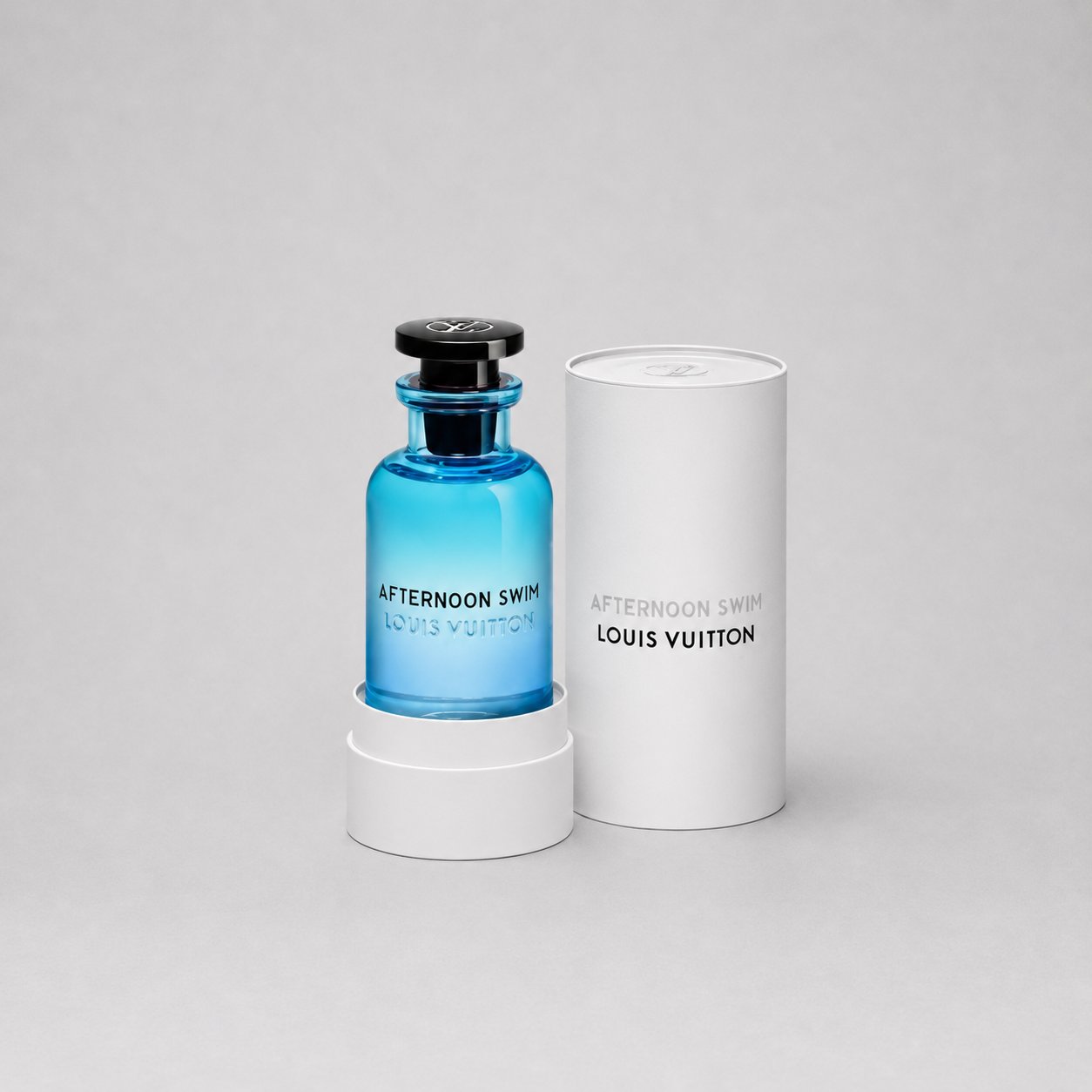 Louis Vuitton Afternoon Swim Sample Spray in a blue glass bottle, displayed with its white cylindrical box.