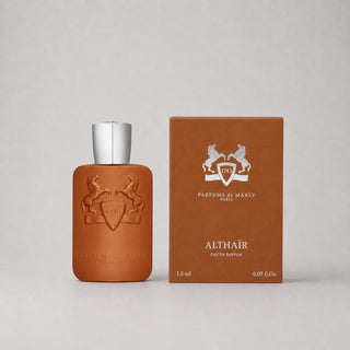 Parfums de Marly Althaïr Sample Spray in a brown bottle with silver cap next to a matching box, 1.5 ml size.