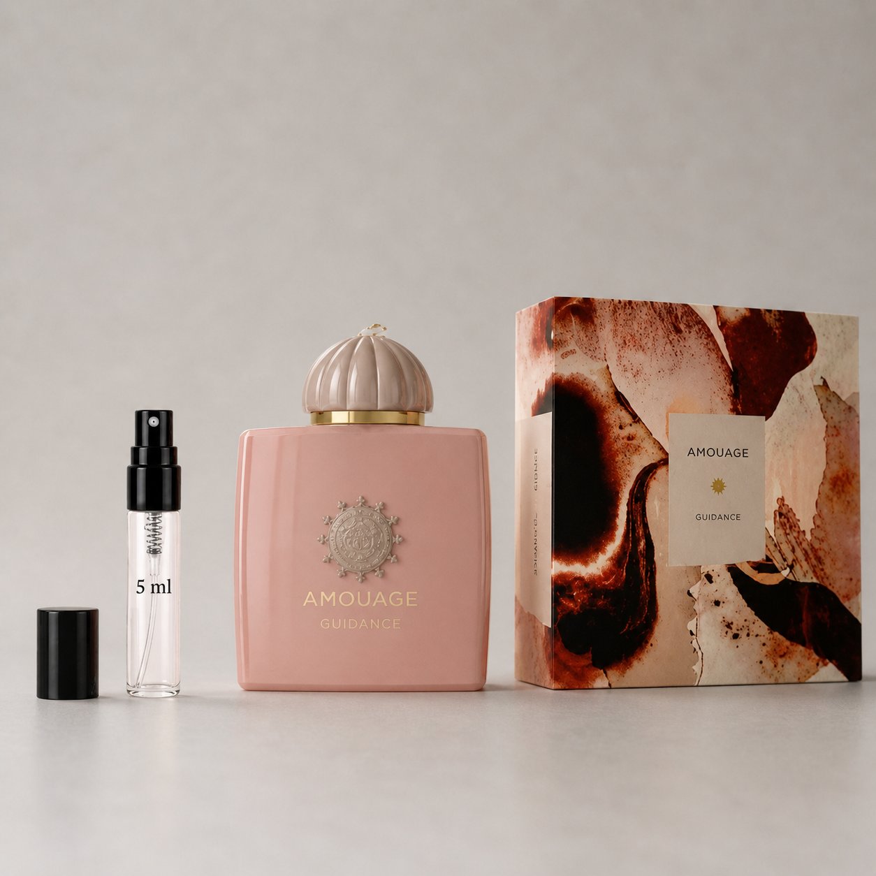 Amouage Guidance Sample Spray featuring a 5 ml spray vial and a decorative box with floral design.