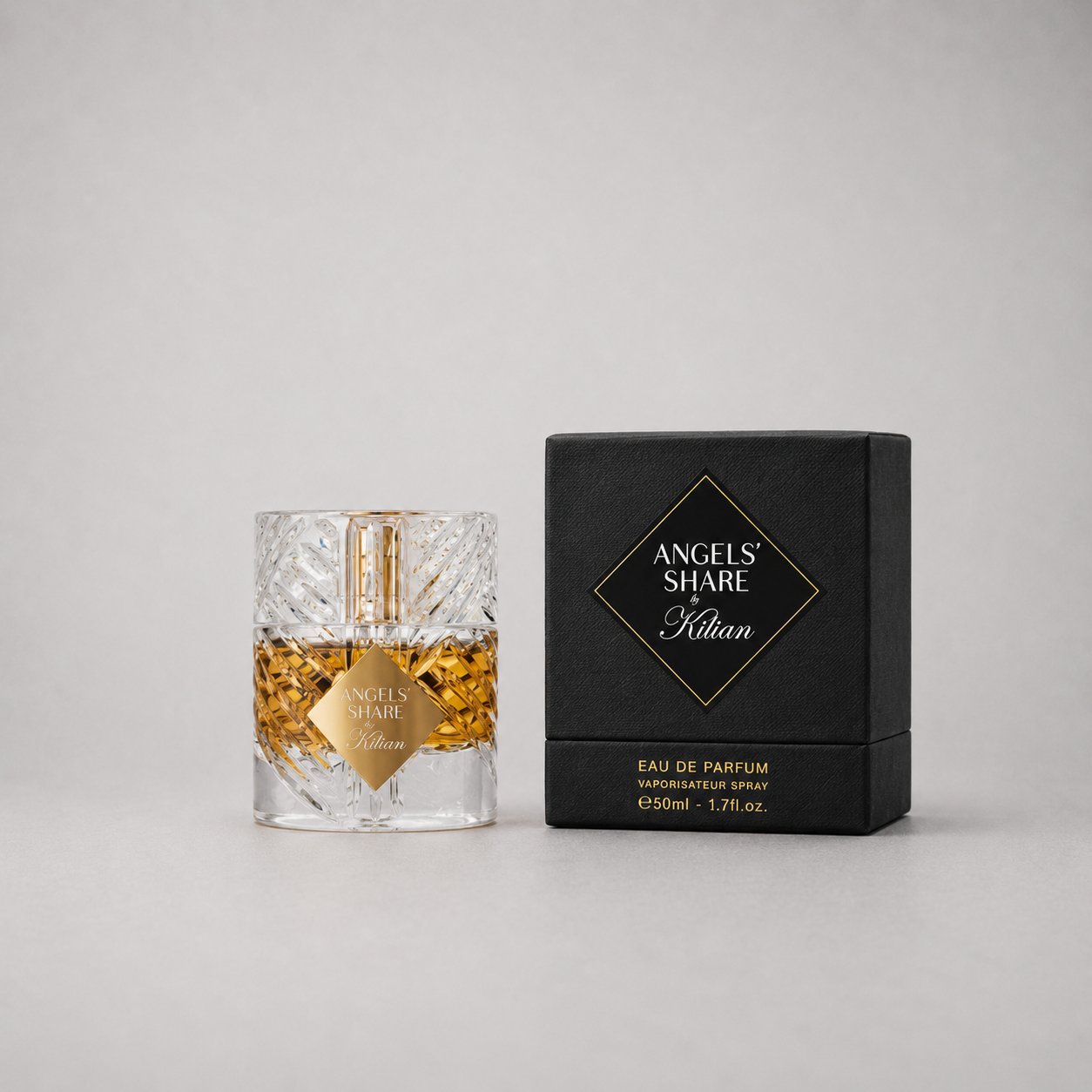 Kilian Angels' Share Sample Spray in a clear bottle with gold accents, next to a black box packaging. 50ml size.