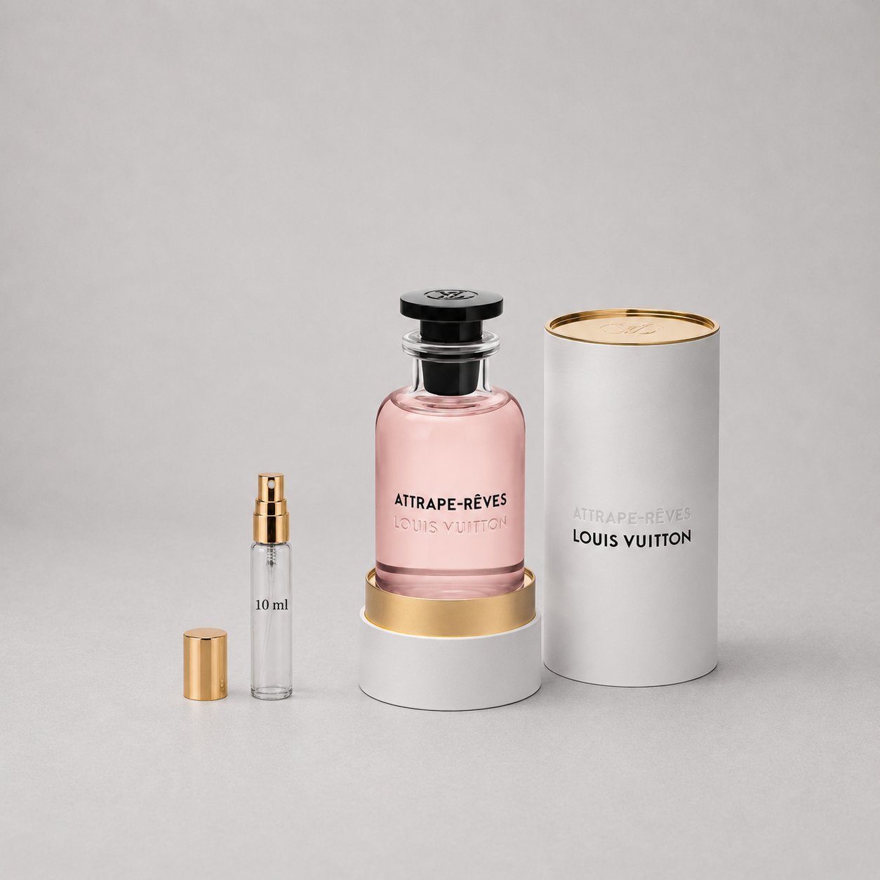 Louis Vuitton Attrape-Rêves Sample Spray features a pink fragrance bottle with a gold cap, alongside a smaller 10ml spray via