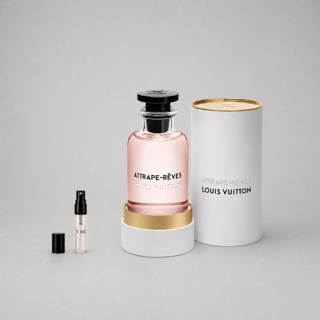 Louis Vuitton Attrape-Rêves Sample Spray features a pink glass bottle with a black cap, displayed beside a smaller spray vial