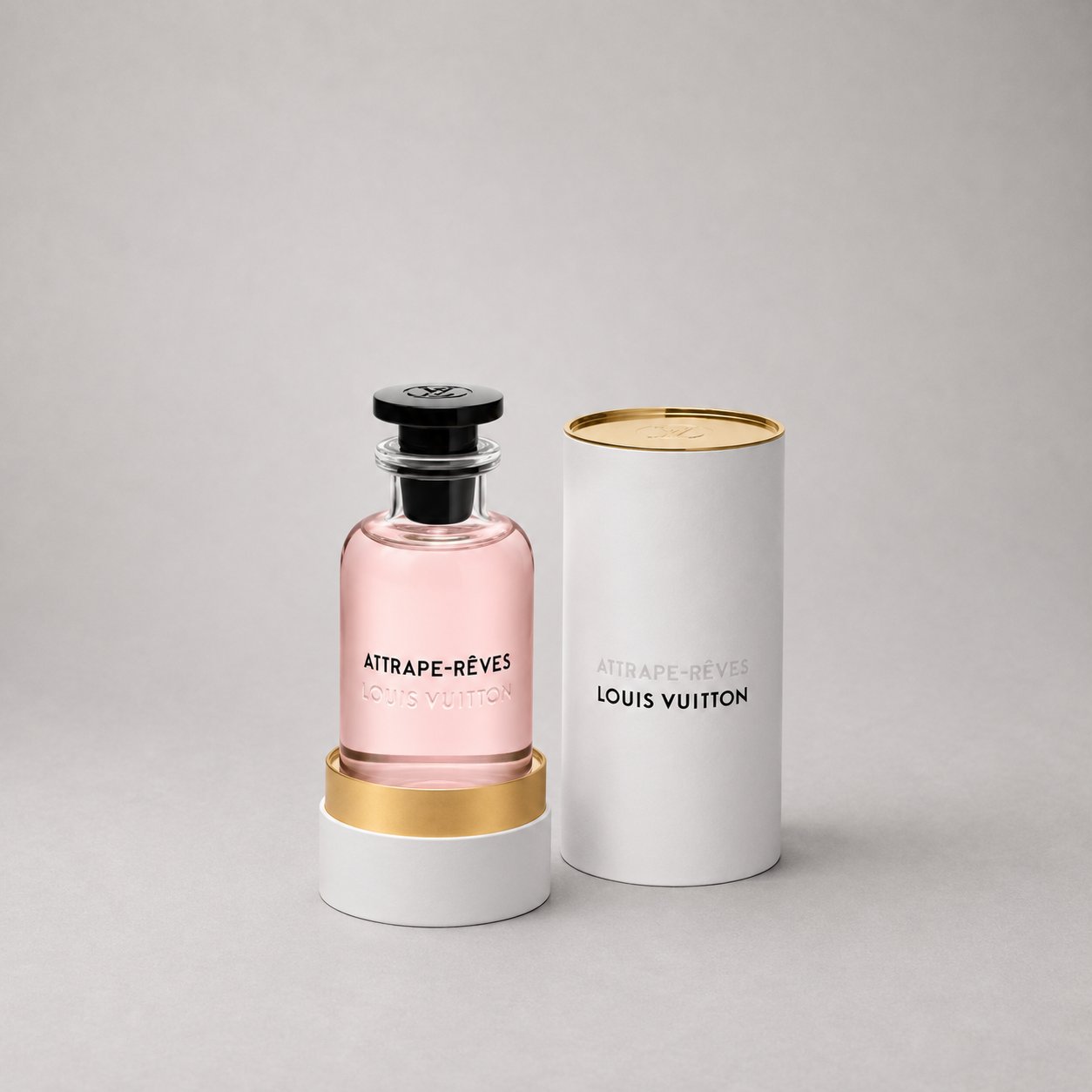 Louis Vuitton Attrape-Rêves Sample Spray in a clear bottle with pink liquid, displayed with a white cylindrical box.
