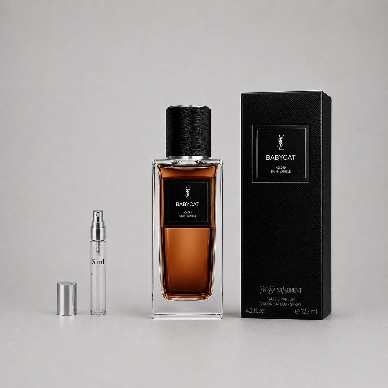 Yves Saint Laurent Babycat Sample Spray featuring a 125ml bottle and a 3ml travel spray, elegantly packaged in a black box.