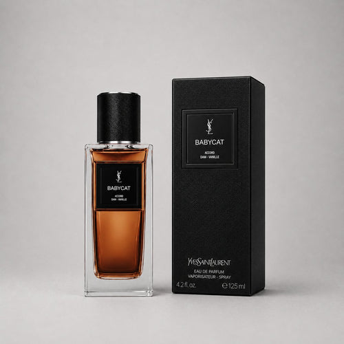 Yves Saint Laurent Babycat Sample Spray features a sleek glass bottle with a dark cap, accompanied by a stylish black box.