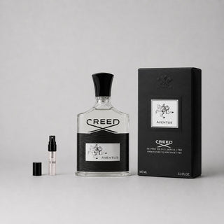 Creed Aventus Sample Spray featuring a 100ml bottle and a travel-sized spray, elegantly packaged in a black box.