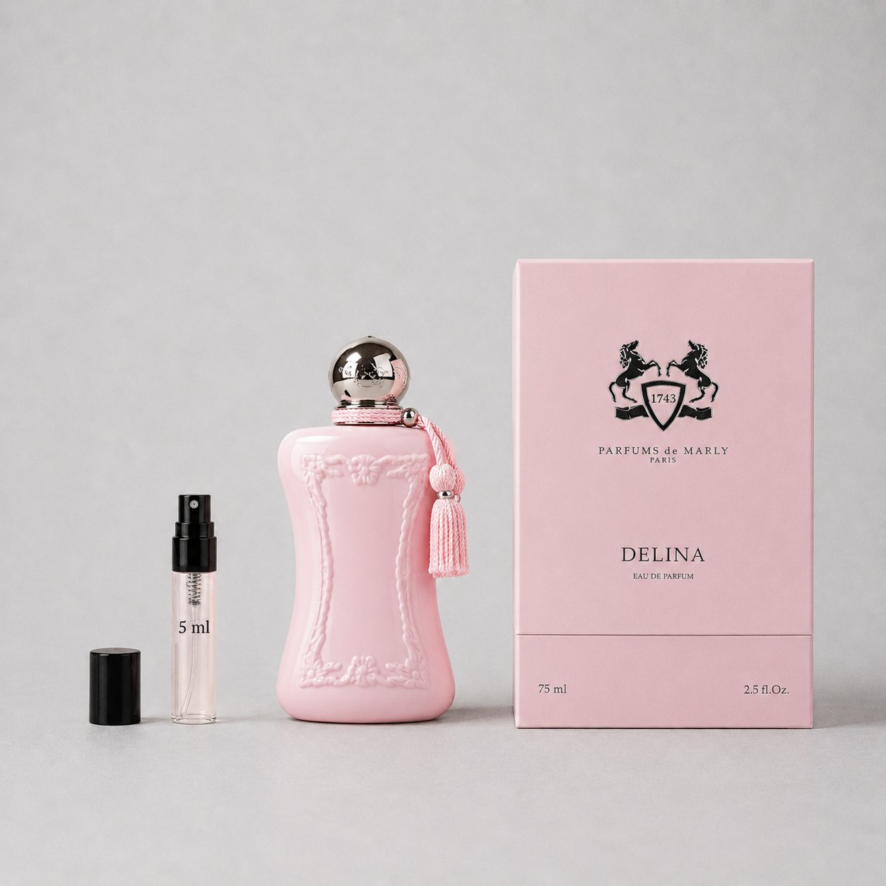 Delina Sample Spray by Parfums de Marly, featuring a pink bottle, tassel, and a 5ml spray vial beside a pink box.