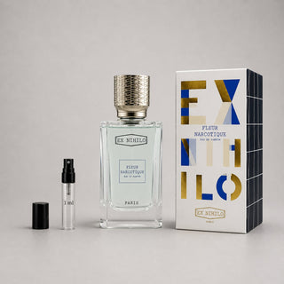 Ex Nihilo Fleur Narcotique Sample Spray featuring a clear bottle with a textured cap, a small spray vial, and a geometric box
