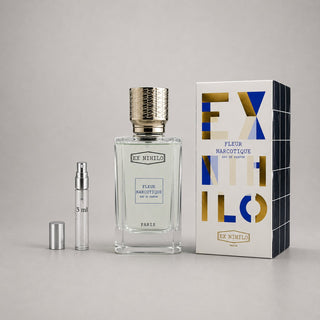 Ex Nihilo Fleur Narcotique Sample Spray with a clear bottle, silver cap, and elegant packaging in blue and gold.