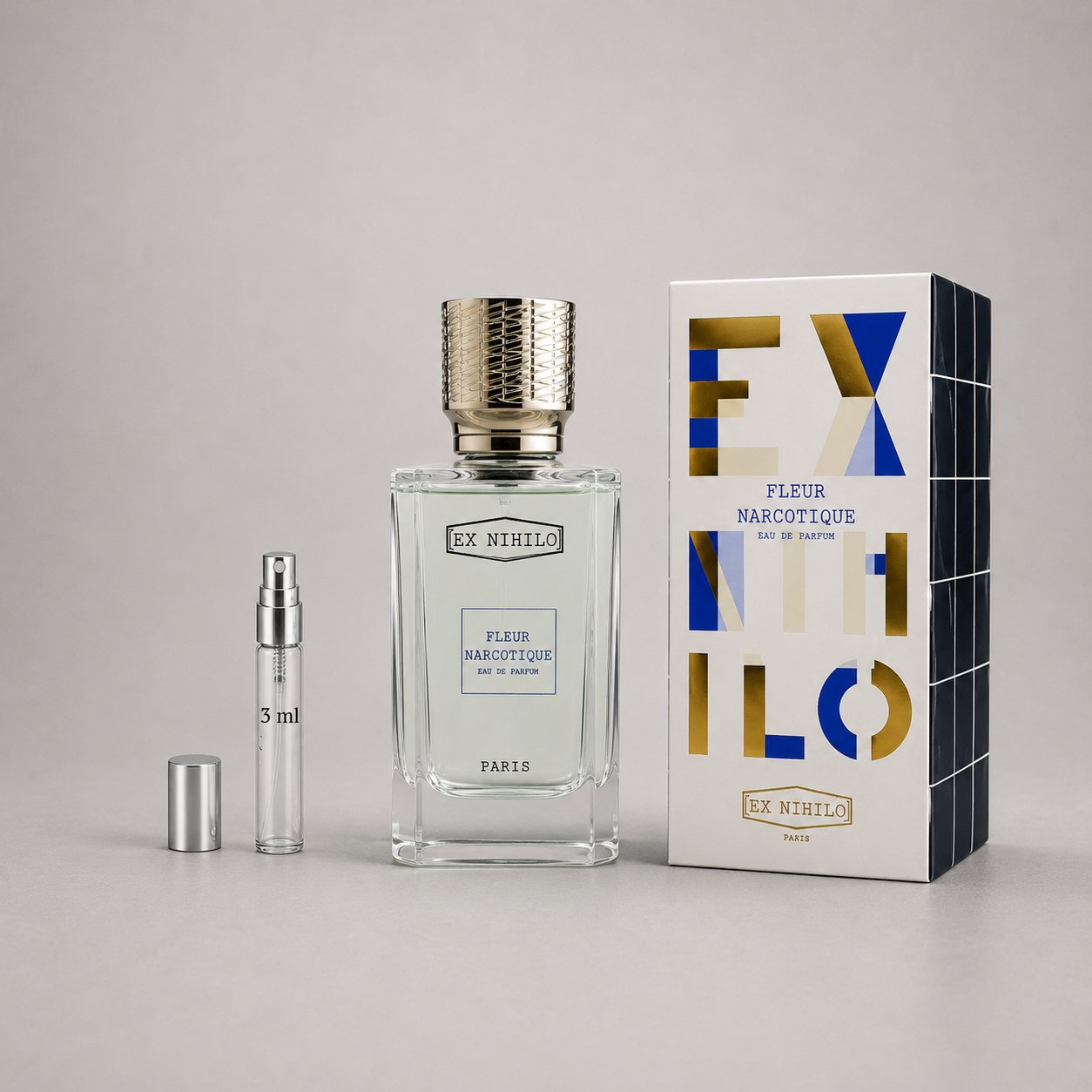Ex Nihilo Fleur Narcotique Sample Spray with a clear bottle, silver cap, and elegant packaging in blue and gold.