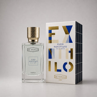 Ex Nihilo Fleur Narcotique Sample Spray in a clear bottle with a gold cap, next to its stylish geometric box.
