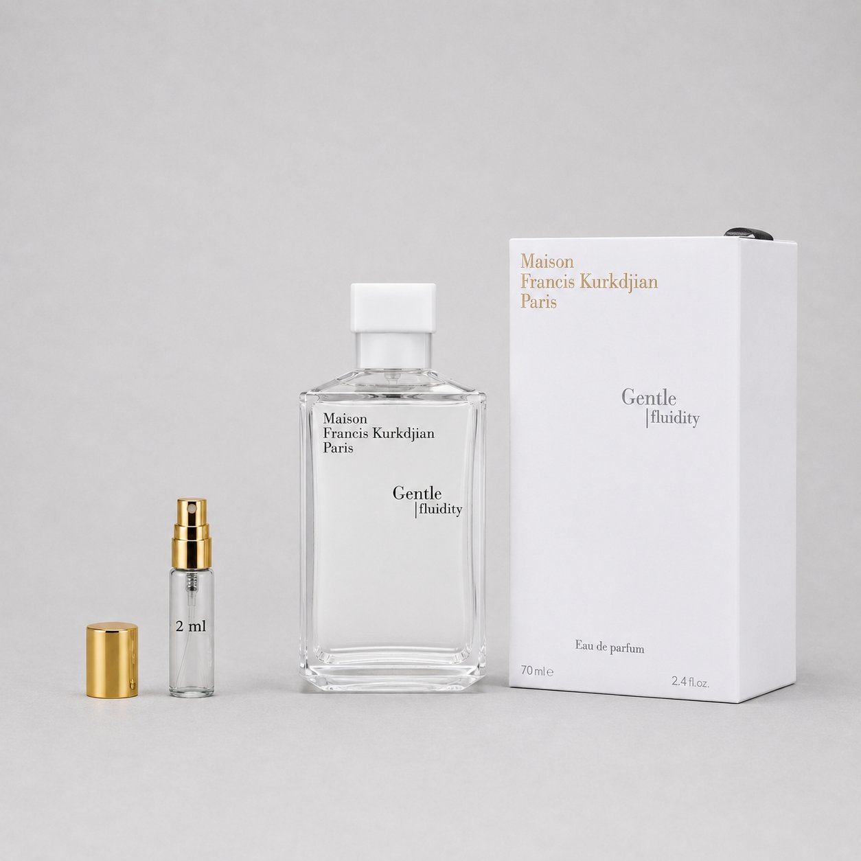 Maison Francis Kurkdjian Gentle Fluidity Silver Sample Spray with a 2ml vial and elegant packaging on a gray background.