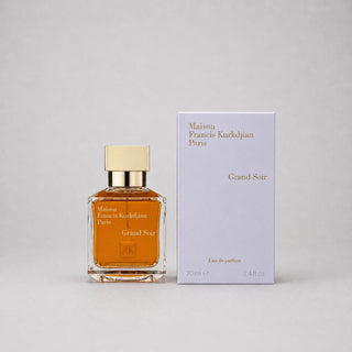 Maison Francis Kurkdjian Grand Soir Sample Spray features a square glass bottle with a gold cap and a warm amber liquid, alon