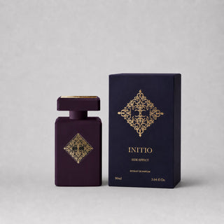 Initio Parfums Privés Side Effect Sample Spray in a purple bottle with gold accents, accompanied by a matching box.