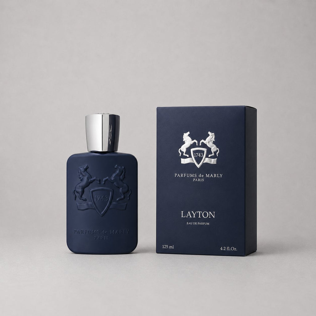 Parfums de Marly Layton sample spray in a dark blue bottle with a silver cap, alongside a matching box.