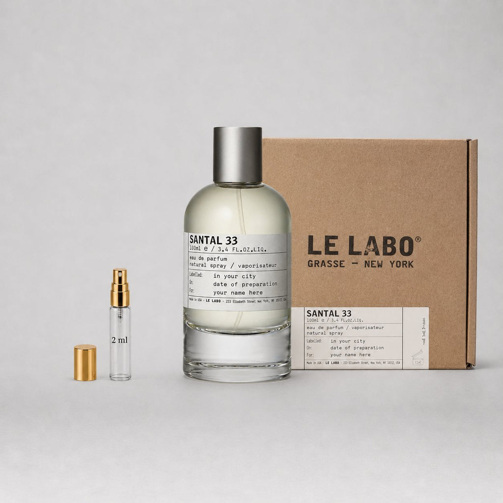 Le Labo Santal 33 Sample Spray featuring a 2ml vial and a larger bottle, packaged in a brown box with brand label.