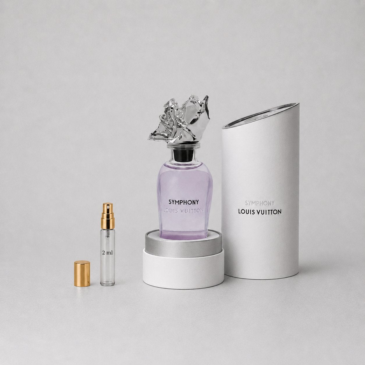Louis Vuitton Symphony Sample Spray featuring a purple bottle, elegant cap, and a 2 ml spray vial in a sleek white box.
