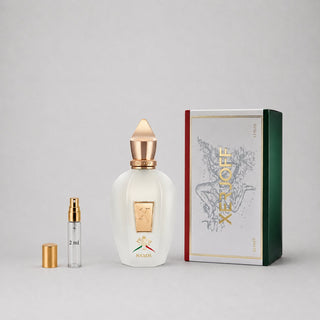 Xerjoff Naxos Sample Spray featuring a white bottle with a gold cap and a green and red box, 2 ml size included.