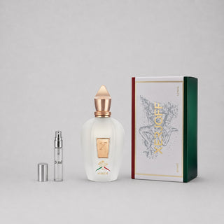 Xerjoff Naxos Sample Spray, 3 ml vial beside a decorative box featuring elegant design and branding.