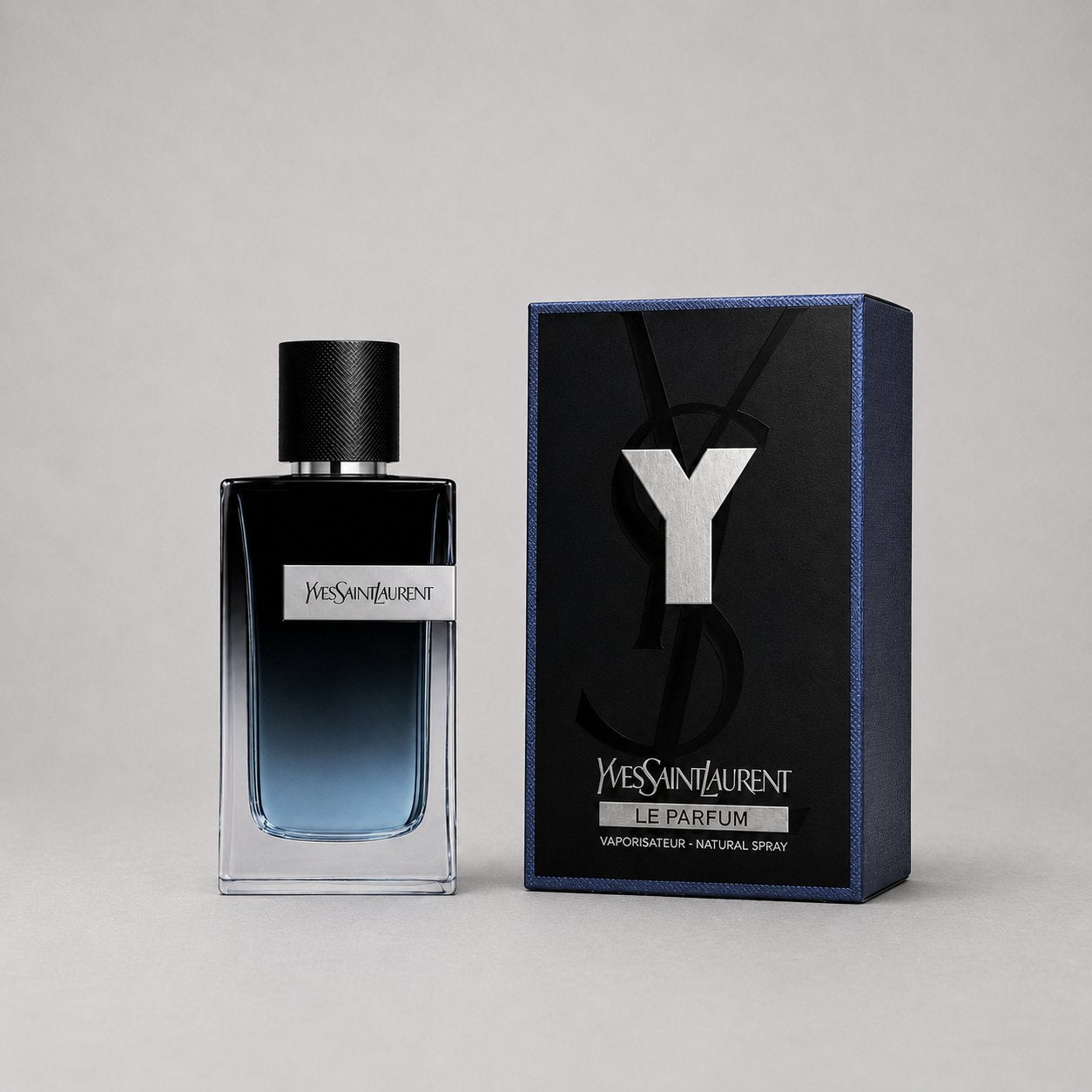 Yves Saint Laurent Y Le Parfum sample spray in a sleek glass bottle with a black cap, accompanied by a stylish blue box.